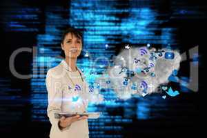 Businesswoman holding tablet with cloud and app icons