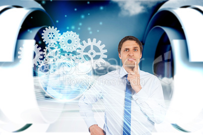 Confused businessman with cogs and wheels graphics
