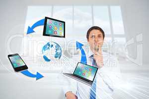 Confused businessman with computer connection graphic