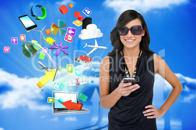 Glamorous brunette using smartphone with app icons and laptop