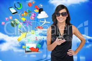 Glamorous brunette using smartphone with app icons and laptop