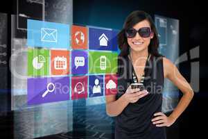 Glamorous brunette using smartphone with app icon menu