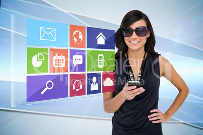 Glamorous brunette using smartphone with app icon menu