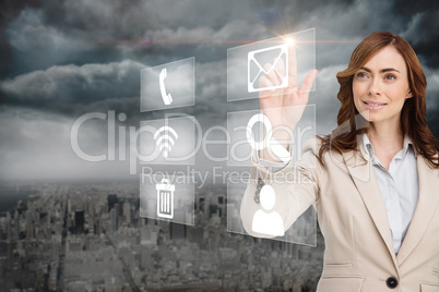 Smiling businesswoman pointing to email on app menu