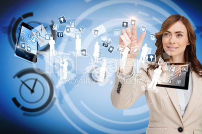 Smiling businesswoman pointing to apps flying between devices