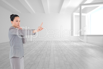 Composite image of thoughtful asian businesswoman pointing