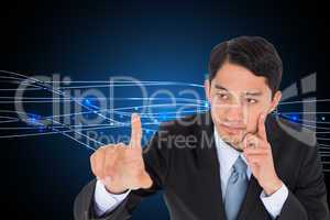 Composite image of thoughtful asian businessman pointing