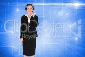 Composite image of good looking woman in suit using headphones a