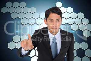 Composite image of serious asian businessman pointing