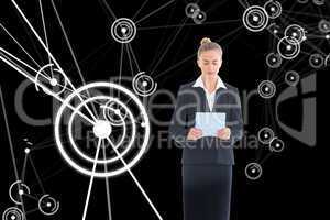 Composite image of businesswoman holding new tablet