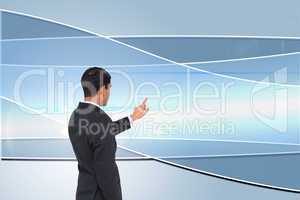 Composite image of asian businessman pointing