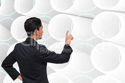 Composite image of unsmiling asian businessman pointing