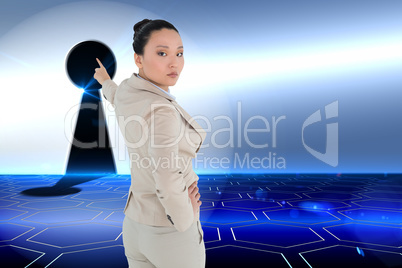 Composite image of unsmiling asian businesswoman pointing