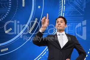 Composite image of unsmiling asian businessman pointing