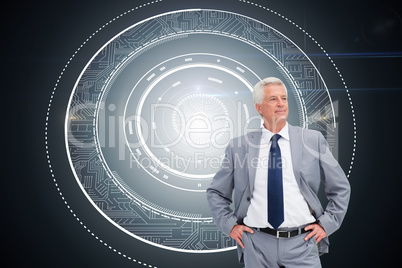 Composite image of man in a suit with his hands on his hips