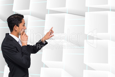 Composite image of thoughtful asian businessman pointing