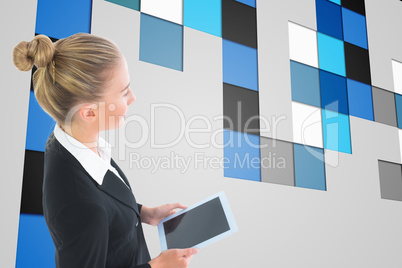 Composite image of businesswoman holding tablet