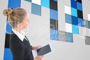 Composite image of businesswoman holding tablet