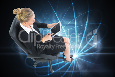 Composite image of businesswoman sitting on swivel chair with ta