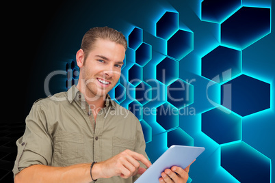 Composite image of happy man using tablet pc