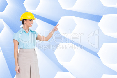 Composite image of smiling attractive architect pointing