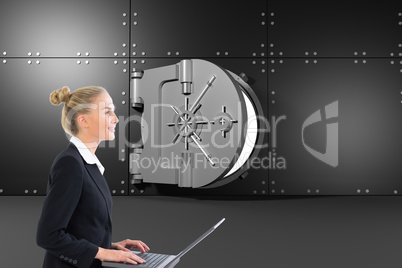 Composite image of businesswoman using laptop