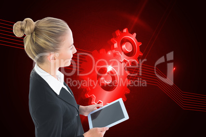 Composite image of businesswoman holding tablet