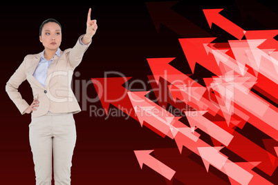 Composite image of unsmiling asian businesswoman pointing