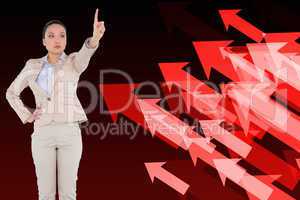 Composite image of unsmiling asian businesswoman pointing