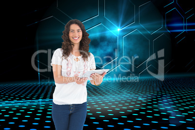 Composite image of smiling casual brunette using her tablet pc