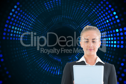 Composite image of businesswoman holding tablet