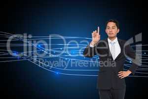 Composite image of unsmiling asian businessman pointing