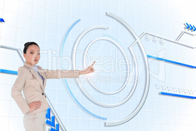 Composite image of unsmiling asian businesswoman pointing