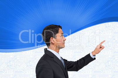 Composite image of serious asian businessman pointing