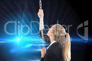 Composite image of businesswoman pulling a chain