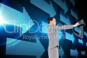 Composite image of unsmiling asian businesswoman pointing