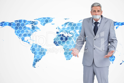 Composite image of businessman gagged with adhesive tape on mout