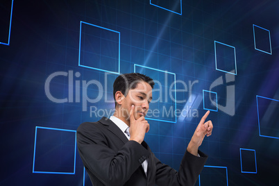 Composite image of thoughtful asian businessman pointing