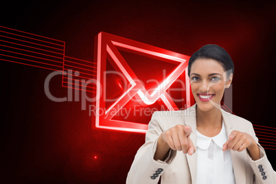 Composite image of smiling businesswoman pointing at the camera