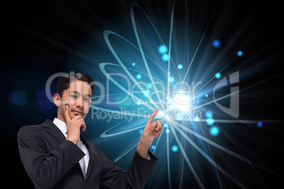 Composite image of thoughtful asian businessman pointing