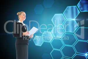 Composite image of businesswoman holding new tablet