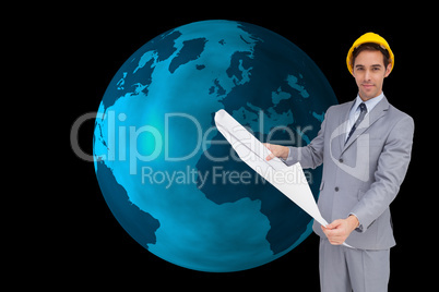 Composite image of serious architect with hard hat holding plans