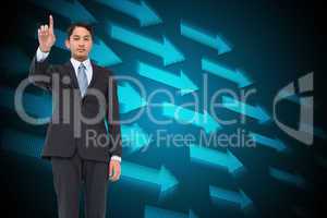 Composite image of serious asian businessman pointing