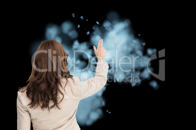 Composite image of brunette businesswoman standing back to camer