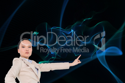 Composite image of unsmiling asian businesswoman pointing