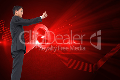 Composite image of serious asian businessman pointing