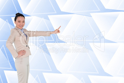 Composite image of smiling asian businesswoman pointing