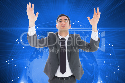 Composite image of unsmiling businessman with arms raised