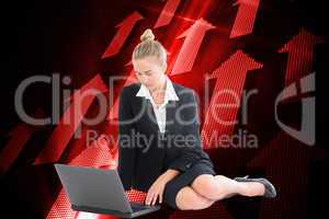 Composite image of businesswoman using laptop