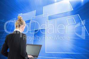 Composite image of businesswoman using laptop